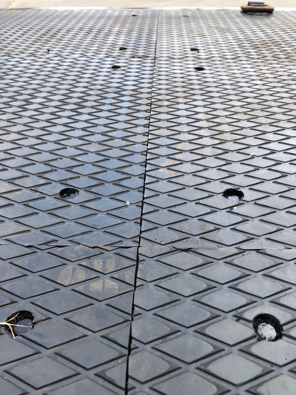 Close-up of the decking’s raised diamond-pattern surface and panel joints